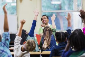 Students raising hands to ask questions